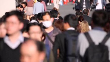 People Are Crossing the Street in Tokyo Shinjuku Area. Business District. Rush Hour Time. Blurry Background
