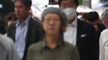 People are Walking on Platform in Metro Train Station Platform in Tokyo. Underground Metro Train During Rush Hour. Peaple are Leaving Station. Asian commuters traveling.
