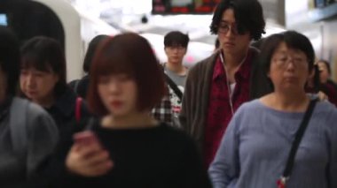 People are Walking on Platform in Metro Train Station Platform in Tokyo. Underground Metro Train During Rush Hour. Peaple are Leaving Station. Asian commuters traveling.