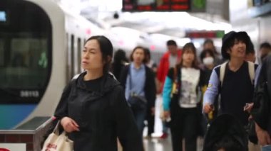 People are Walking on Platform in Metro Train Station Platform in Tokyo. Underground Metro Train During Rush Hour. Peaple are Leaving Station. Asian commuters traveling.