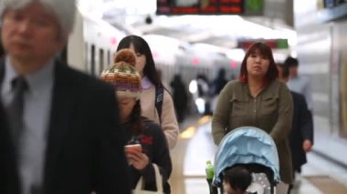 People are Walking on Platform in Metro Train Station Platform in Tokyo. Underground Metro Train During Rush Hour. Peaple are Leaving Station. Asian commuters traveling.