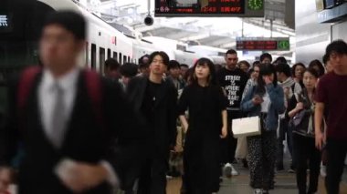 People are Walking on Platform in Metro Train Station Platform in Tokyo. Underground Metro Train During Rush Hour. Peaple are Leaving Train. Asian commuters traveling.
