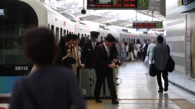 People are Walking on Platform in Metro Train Station Platform in Tokyo. Underground Metro Train During Rush Hour. Peaple are Leaving Train. Asian commuters traveling.
