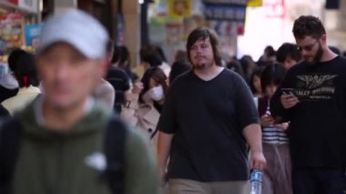 People in Tokyo City. Business District. Rush Hour Time People Are Walking on the Sidewalk. Japanese People. Blurry Background