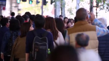 People in Tokyo City. Business District. Rush Hour Time People Are Walking on the Sidewalk. Japanese People. Blurry Background