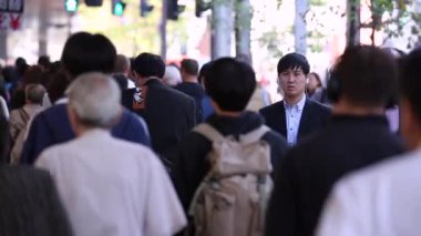 People in Tokyo City. Business District. Rush Hour Time People Are Walking on the Sidewalk. Japanese People. Blurry Background