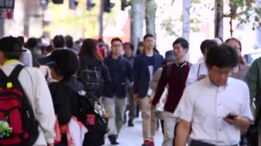 People in Tokyo City. Business District. Rush Hour Time People Are Walking on the Sidewalk. Japanese People. Blurry Background
