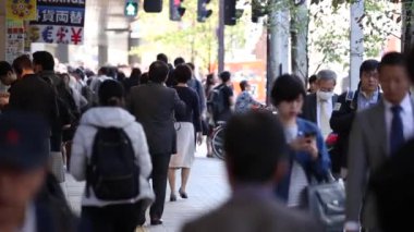 People in Tokyo City. Business District. Rush Hour Time People Are Walking on the Sidewalk. Japanese People. Blurry Background