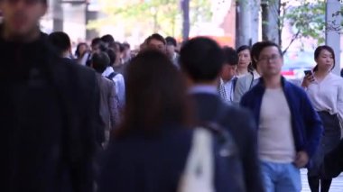 People in Tokyo City. Business District. Rush Hour Time People Are Walking on the Sidewalk. Japanese People. Blurry Background