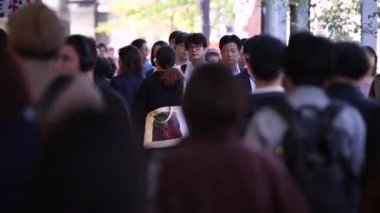 People in Tokyo City. Business District. Rush Hour Time People Are Walking on the Sidewalk. Japanese People. Blurry Background