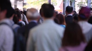 People in Tokyo City. Business District. Rush Hour Time People Are Walking on the Sidewalk. Japanese People. Blurry Background