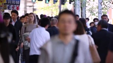 People in Tokyo City. Business District. Rush Hour Time People Are Walking on the Sidewalk. Japanese People. Blurry Background