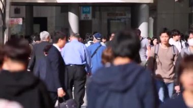 People in Tokyo City. Business District. Rush Hour Time People Are Walking on the Sidewalk. Japanese People. Blurry Background