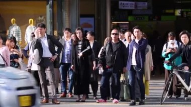 People in Tokyo City. Business District. Rush Hour Time People Are Walking on the Sidewalk. and Waiting for the Green Light to Cross The Street. Japanese People