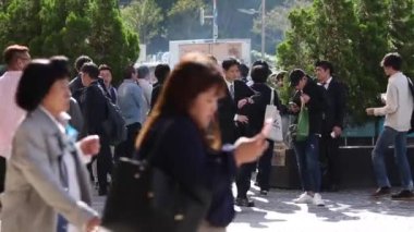 Public Smoking Area in Tokyo, Japan. People Are Smoking Next To Shinjuku Train Station. Sunny Day