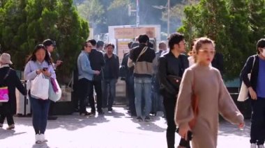 Public Smoking Area in Tokyo, Japan. People Are Smoking Next To Shinjuku Train Station. Sunny Day