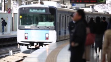 Metro Train Station Platform in Tokyo. Underground Metro Train During Rush Hour is Approaching. Blurry View. Asian commuters traveling.