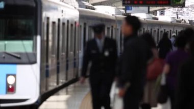 Metro Train Station Platform in Tokyo. Underground Metro Train During Rush Hour is Approaching. Blurry View. Asian commuters traveling.