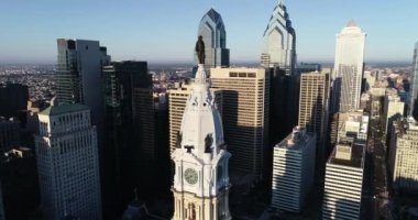 Philadelphia Belediye Binası Kulesi ve William Penn 'in bronz heykeli. Şehir manzarası ve Arkaplanda Güzel Günbatımı Işığı. Pennsylvania 4k