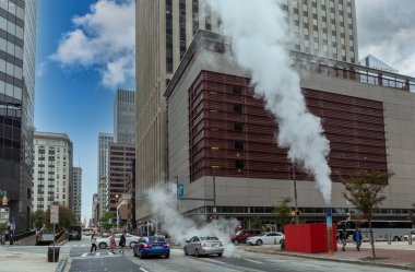Baltimore, Maryland - October 03, 2019: Baltimore Downtown Street Water Steam. Traffic Vehicles. Steam and hot water. Maryland