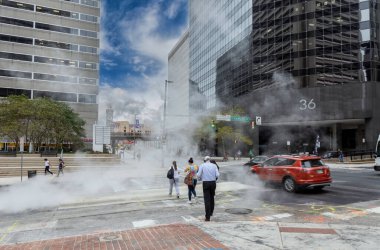 Baltimore, Maryland - October 03, 2019: Baltimore Downtown Street Water Steam. People are waiting to Cross The Street.. Steam and hot water. Maryland