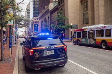 Baltimore, Maryland - October 03, 2019: Baltimore Police Vehicle with Flashing Lights On. Cityscape in Background.
