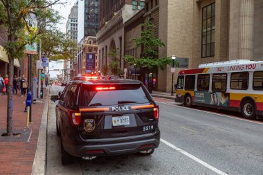 Baltimore, Maryland - October 03, 2019: Baltimore Police Vehicle with Flashing Lights On. Cityscape in Background.