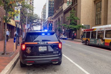 Baltimore, Maryland - October 03, 2019: Baltimore Police Vehicle with Flashing Lights On. Cityscape in Background.