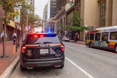 Baltimore, Maryland - October 03, 2019: Baltimore Police Vehicle with Flashing Lights On. Cityscape in Background.