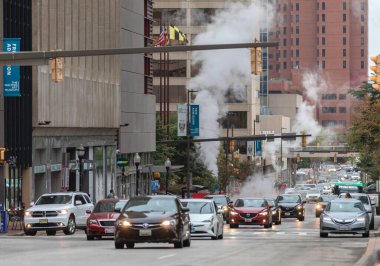 Baltimore, Maryland - October 03, 2019: Baltimore Downtown Street Water Steam. Traffic Vehicles. Steam and hot water. Maryland