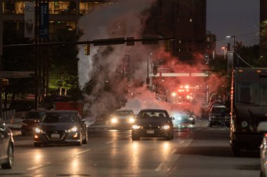 Baltimore, Maryland - October 03, 2019: Night Traffic in Baltimore, Maryland. Vehicles and Fire Department Vehicle with Flashing Lights in Background.