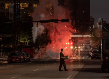 Baltimore, Maryland - October 03, 2019: Night Traffic in Baltimore, Maryland. Vehicles and Fire Department Vehicle with Flashing Lights in Background.
