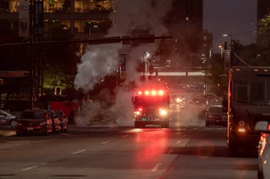 Baltimore, Maryland - October 03, 2019: Traffic in Baltimore with Vehicles and Fire Department Vehicle with Flashing Lights in Background.