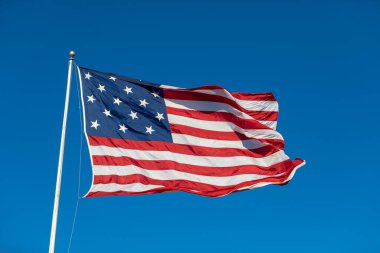 USA Flag Waving in Blue Background. Clear Blue Sky. American Wave Flag
