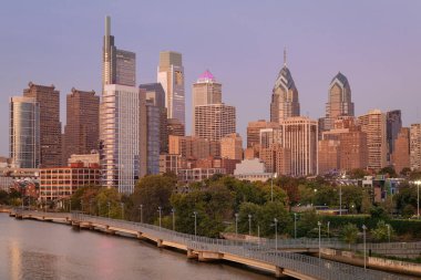 Philadelphia Downtown skyline with the Schuylkill river. Beautiful Sunset Light. Schuylkill River Trail in Background. City skyline glows under the beautiful sunset light. PA, USA.