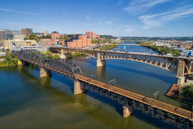 Pittsburgh Skyline with Downtown and Business District. Train Bridge and Liberty Bridge. Clear blue sky in the background.