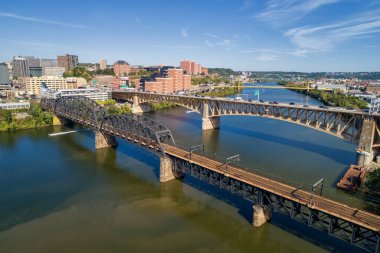 Pittsburgh Skyline with Downtown and Business District. Train Bridge and Liberty Bridge. Clear blue sky in the background.