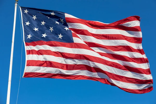 USA Flag Waving in Blue Background. Clear Blue Sky. American Wave Flag