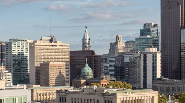Philadelphia City Center and Business District Skyscrapers. Cloudy Blue Sky, Beautiful Sunlight. City Hall Statue in Background