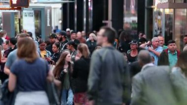 Urban Crowd of commuters, blurry unrecognizable tourists walking in Manhattan, NYC. 7th Avenue. Shallow Depth of Field. Daytime