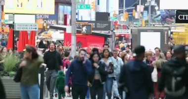 Anonymous Urban Crowd of commuters, unrecognizable tourists  walking in Manhattan, NYC. 7th Aveue. Blurry Background. Traffic Lights. 4k