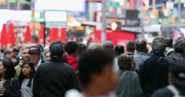 Urban Crowd of Anonymous commuters, unrecognizable tourists  walking in Manhattan, NYC. Times Square. Blurry Background. Traffic Lights. 4k