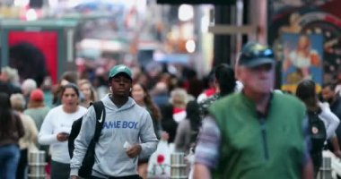 Urban Crowd of Anonymous commuters, unrecognizable tourists  walking in Manhattan, NYC. Times Square. Blurry Background. Lost Tourist. 4k