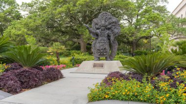 Statue in Louis Armstrong Park. Blooming Flower around. New Orleans, Louisiana