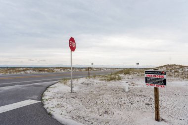 Stop Sign on the road and Sign of Area Closed. Do Not Enter. Pensacola, Florida.