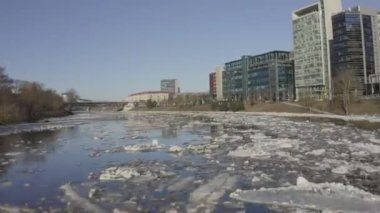 Ice Drift In Vilnius, Capital of Lithuania. River Neris. Ice floes float on the river in the spring. Ice drift movement. Winter landscape. Melting ice water, global warming climate change concept.