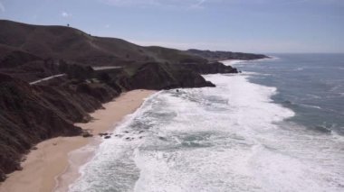 Gray Whale Cove State Beach in California. Ocean waves and clear blue sky in background