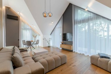 The Stylish Spacious Luxury Interior Design of Living Room with Design Gray Sofa, Coffee Table, Decoration, Pillows in Modern Home Decor. Modern Living Room