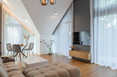 The Stylish Spacious Luxury Interior Design of Living Room with Design Gray Sofa, Coffee Table, Decoration, Pillows in Modern Home Decor. Modern Living Room