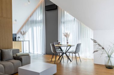 The Stylish Spacious Luxury Interior Design of Living Room with Design Gray Sofa, Coffee Table, Decoration, Pillows in Modern Home Decor. Modern Living Room